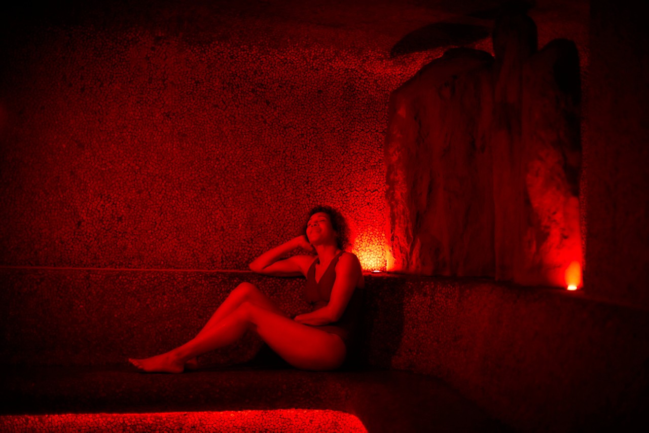 Woman relaxing in a glowing Volcanic Steam room.